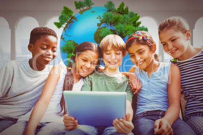 Composite image of happy children using digital tablet at park