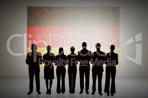 Composite image of silhouette of business people in a row