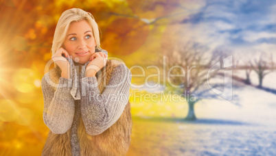 Composite image of blonde in winter clothes smiling