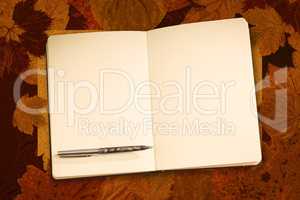 Composite image of notebook and pen