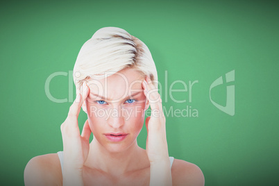 Composite image of beautiful blonde suffering from headache look