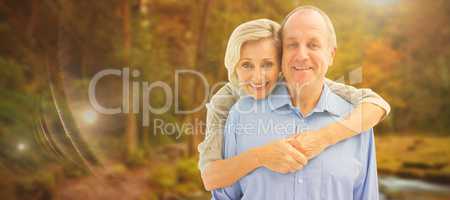 Composite image of happy mature couple embracing smiling at came