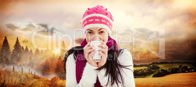 Composite image of winter brunette with coffee