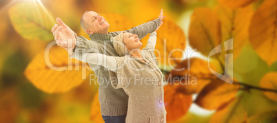 Composite image of happy mature couple in winter clothes