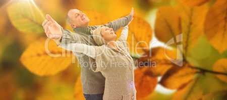 Composite image of happy mature couple in winter clothes