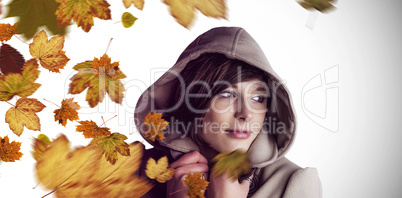Composite image of beautiful woman wearing winter coat looking a