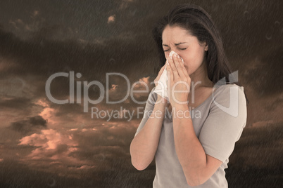 Composite image of sick brunette blowing her nose