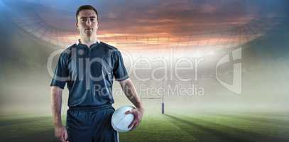 Composite image of rugby player holding a rugby ball
