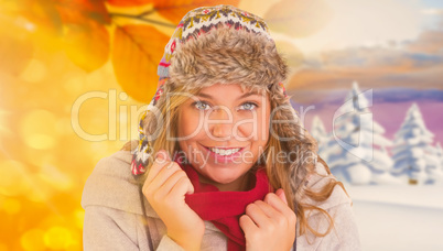 Composite image of happy blonde in winter clothes