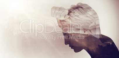 Composite image of sad blonde woman with her head on wall