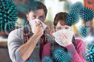 Composite image of couple blowing noses into tissues