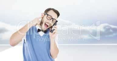 Composite image of geeky hipster talking on a retro cellphone