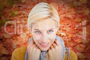 Composite image of smiling woman wearing a scarf