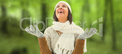 Composite image of brunette in warm clothing