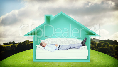 Composite image of businessman lying on sofa