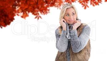 Composite image of blonde in winter clothes smiling