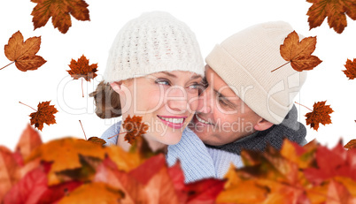 Composite image of casual couple in warm clothing