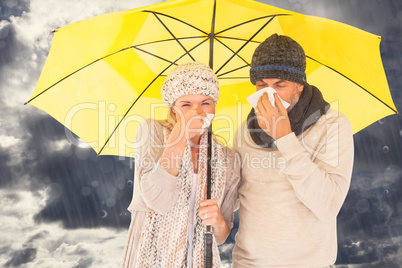 Composite image of couple sneezing in tissue while standing unde