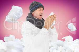 Composite image of sick man in winter fashion sneezing