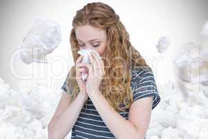 Composite image of sick blonde woman blowing her nose