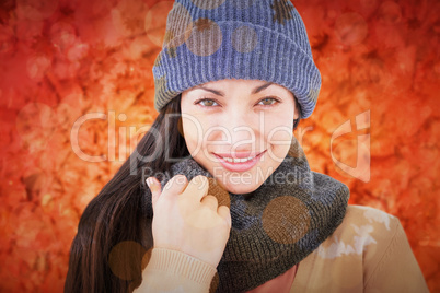 Composite image of attractive brunette looking at camera wearing