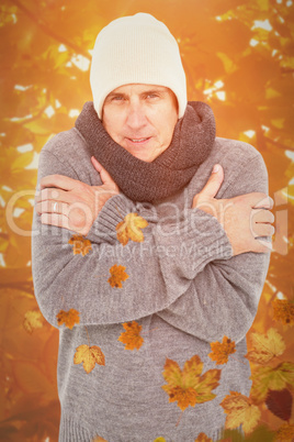 Composite image of casual man shivering in warm clothing