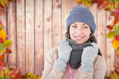 Composite image of smiling brunette wearing warm clothes