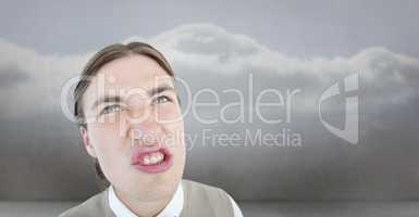 Composite image of geeky hipster grimacing