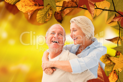 Composite image of happy mature couple smiling at each other