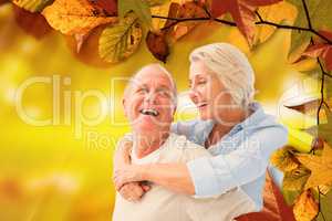 Composite image of happy mature couple smiling at each other