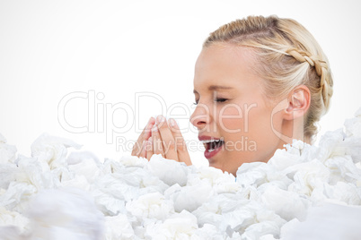 Composite image of blonde woman sneezing with hands in front of