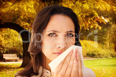 Composite image of brunette with a cold