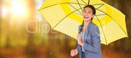 Composite image of portrait of happy businesswoman holding umbre