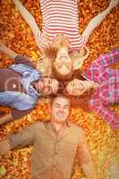 Composite image of friends lying in a circle and smiling at came