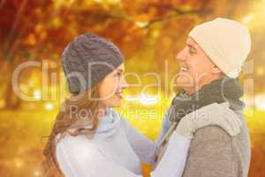 Composite image of happy couple in warm clothing