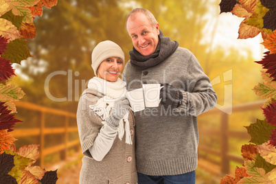 Composite image of happy mature couple in winter clothes holding