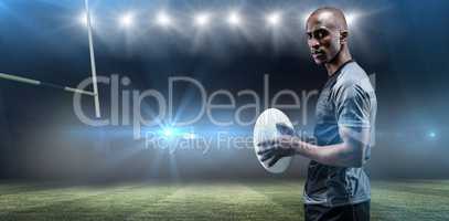 Composite image of portrait of confident athlete standing with rugby ball