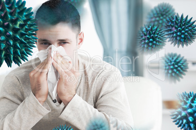 Composite image of young man blowing his nose