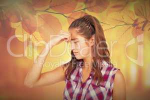 Composite image of a pretty brunette with headache