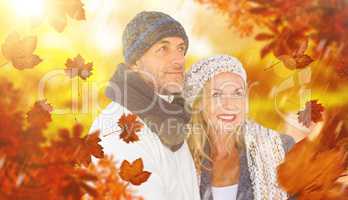 Composite image of cheerful couple in warm clothing