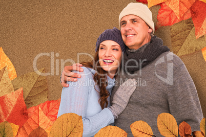 Composite image of couple in warm clothing embracing