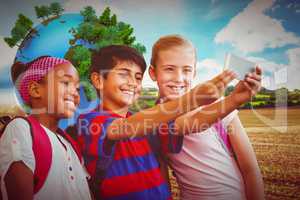 Composite image of happy kids taking selfie in school corridor