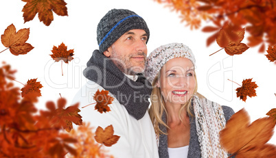 Composite image of cheerful couple in warm clothing