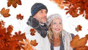 Composite image of cheerful couple in warm clothing