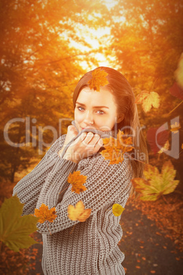 Composite image of pretty girl in winter jumper smiling at camer