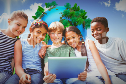 Composite image of happy children using digital tablet at park