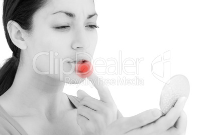 Composite image of worried woman looking at her lips