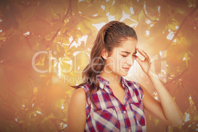 Composite image of a pretty brunette with headache