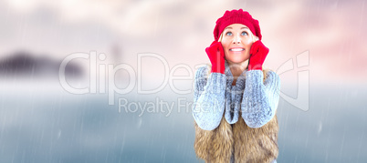 Composite image of blonde in winter clothes smiling