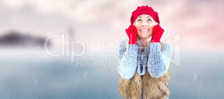 Composite image of blonde in winter clothes smiling